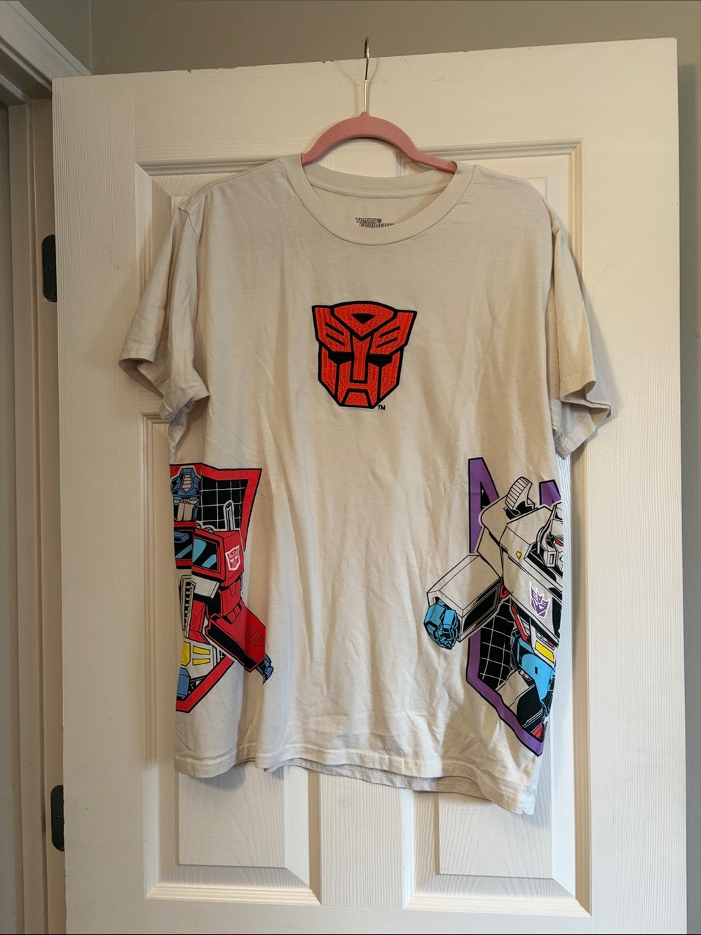 Hasbro Cream Transformers Graphic Tee with Red, Purple, Blue Accents